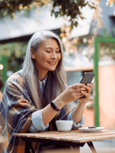 Woman at outdoor terrace looking at her phone