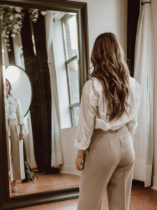 woman staring at herself in the mirror